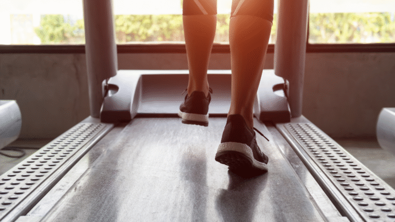 A woman walking on a treadmill to get fit and healthy while taking GLP-1 medications