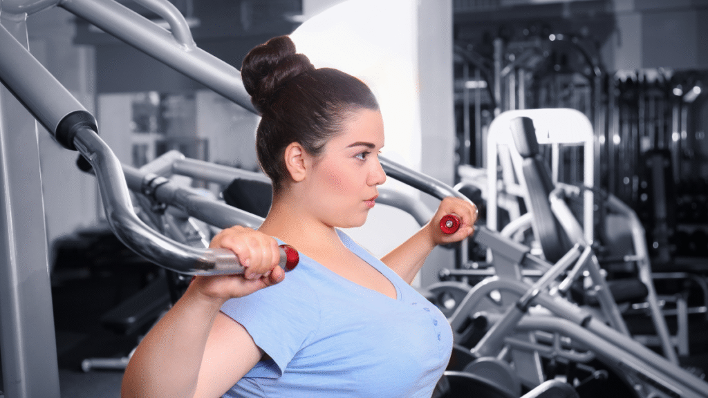 Strong woman weight training w gym equip.