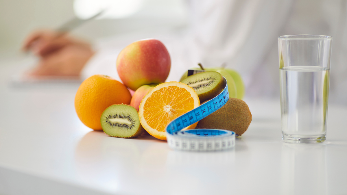 Illustration of citrus fruit and measuring tape to show how obesity and weight loss can occur