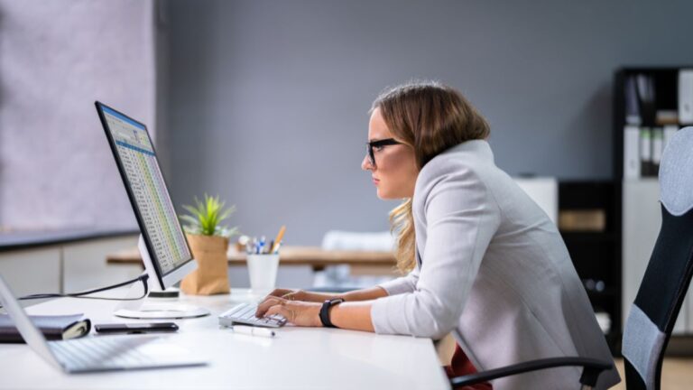 Woman Sitting In Bad Posture Working on PC