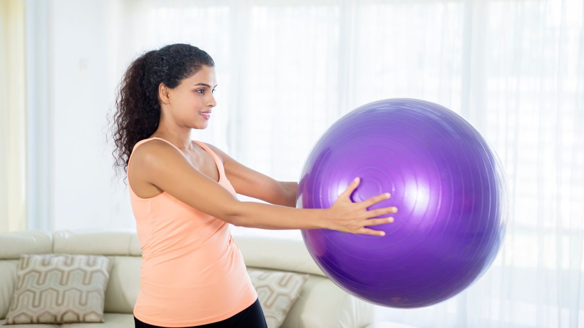 Woman Doing Exercise with Ball by Creativa Images