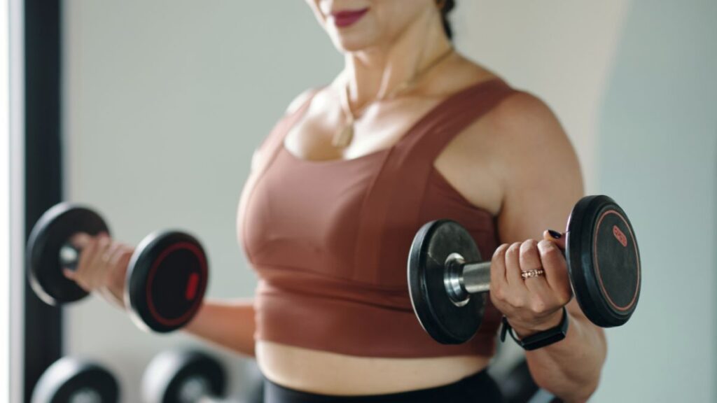 Muscular Woman Lifting Dumbbells